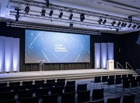 corporate communications AV setup with stage and display